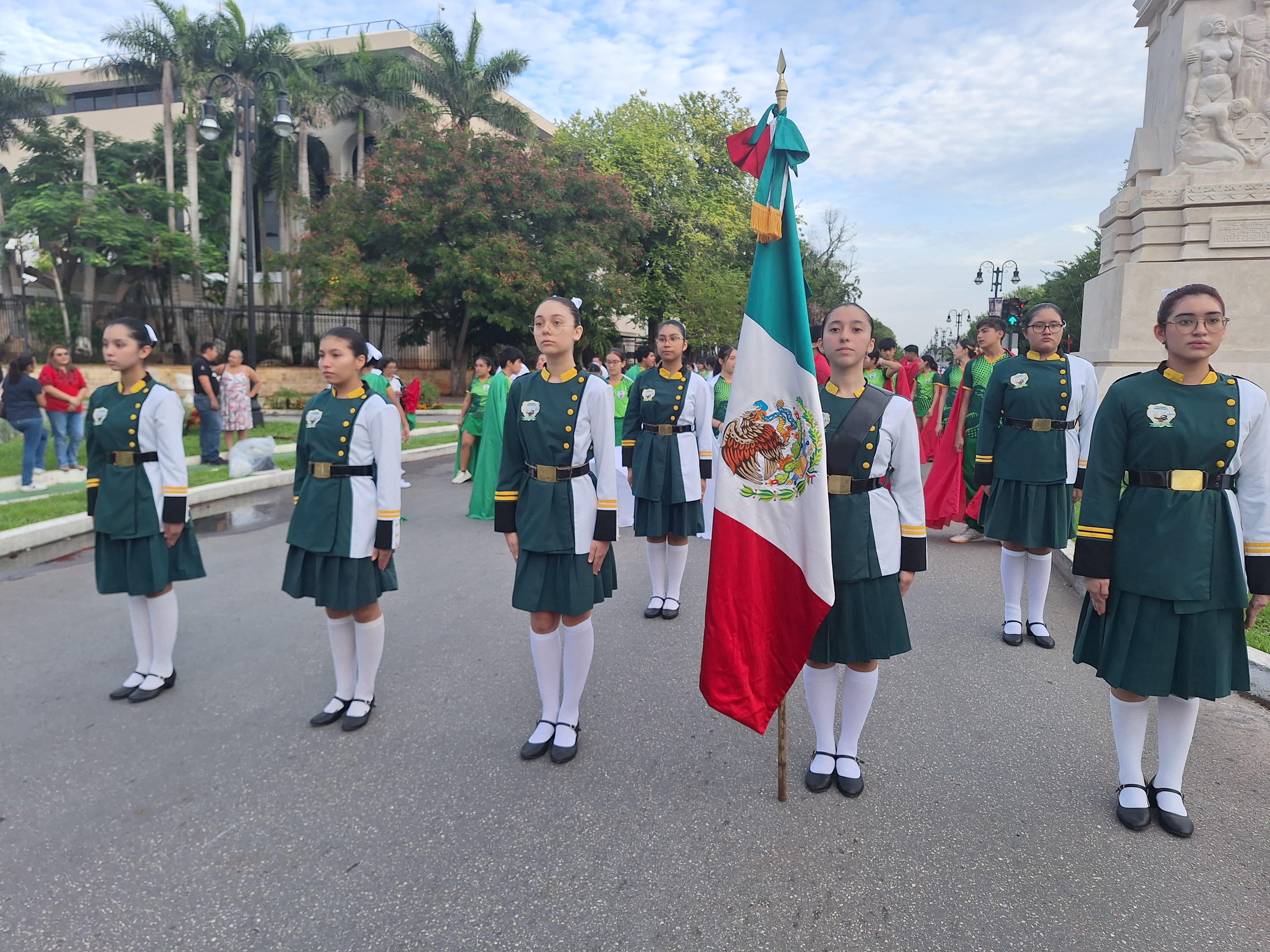Alumnas de la escolta del colegio americano en desfile con bandera de México